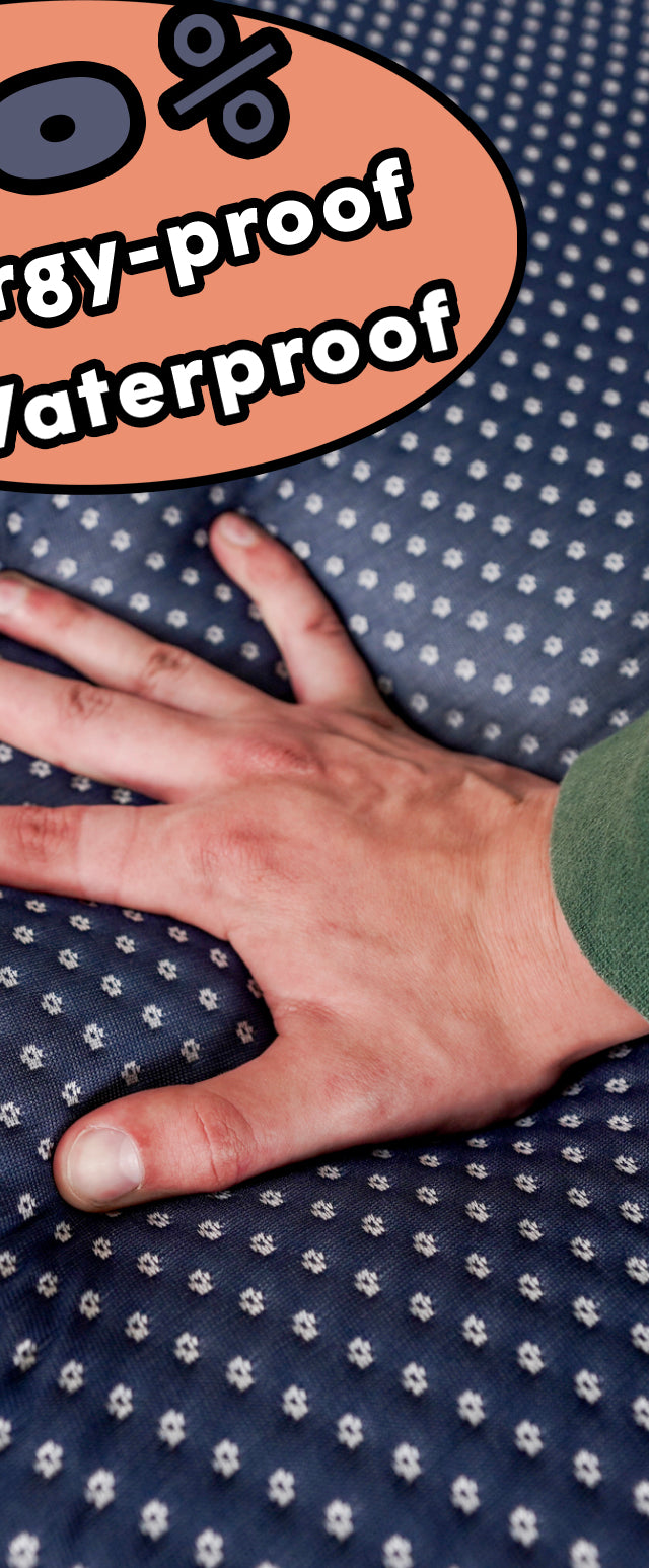 Hand pressing into Cornell Bigger Bed memory foam topper with 100% allergy-proof and waterproof cover.